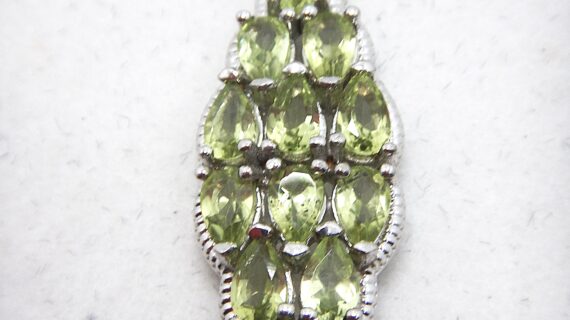 Rhodium plated 925 sterling silver pendant with natural Peridot Approx size  39mm x 12mm Matching ring & earrings available
