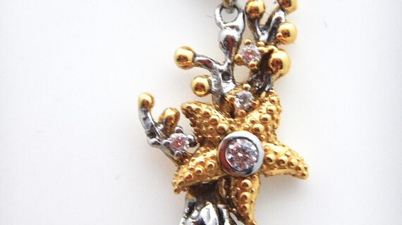 Rhodium & gold plated 925 sterling silver pendant representing coral set with white cubic zirconia Approx size  49mm long