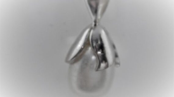 Rhodium plated 925 sterling silver pendant set with natural freshwater pearl Approx size  24mm long Matching earrings available