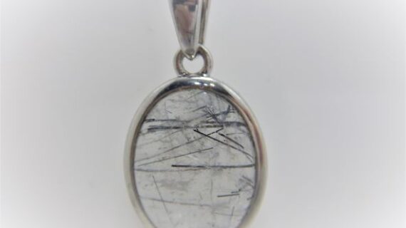 Rhodium plated 925 sterling silver oval pendant with natural Rutile quartz Approx size  21mm x 14.5mm
