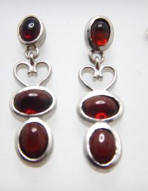 Rhodium plated 925 sterling silver earrings set with natural Garnet Approx size  31mm long Matching pendant available