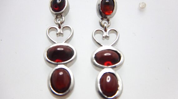 Rhodium plated 925 sterling silver earrings set with natural Garnet Approx size  31mm long Matching pendant available
