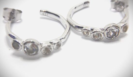 Rhodium plated 925 sterling silver earrings set with natural white topaz Approx size 5mm wide x 17mm diam