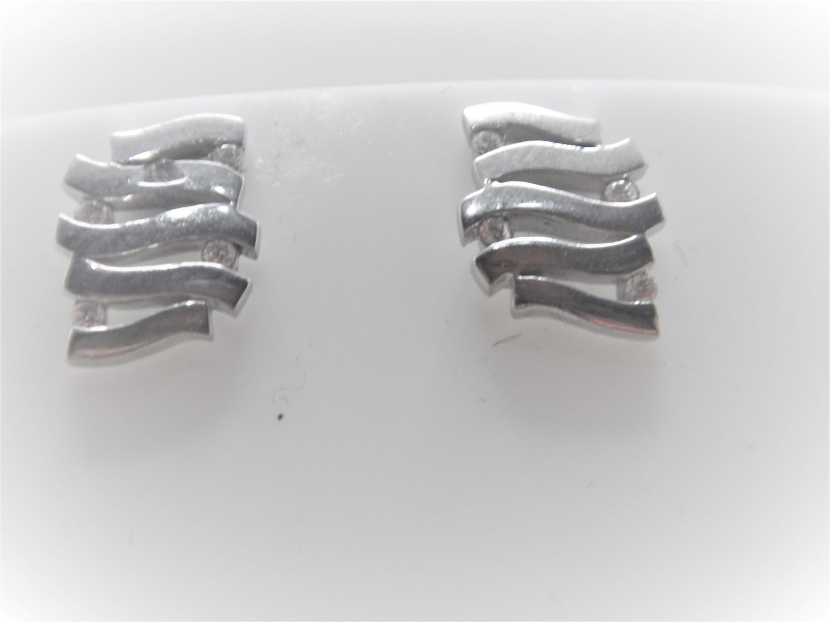 Rhodium plated 925 sterling silver earrings set with white cubic zirconia Approx sise 11mm x 9.5mm