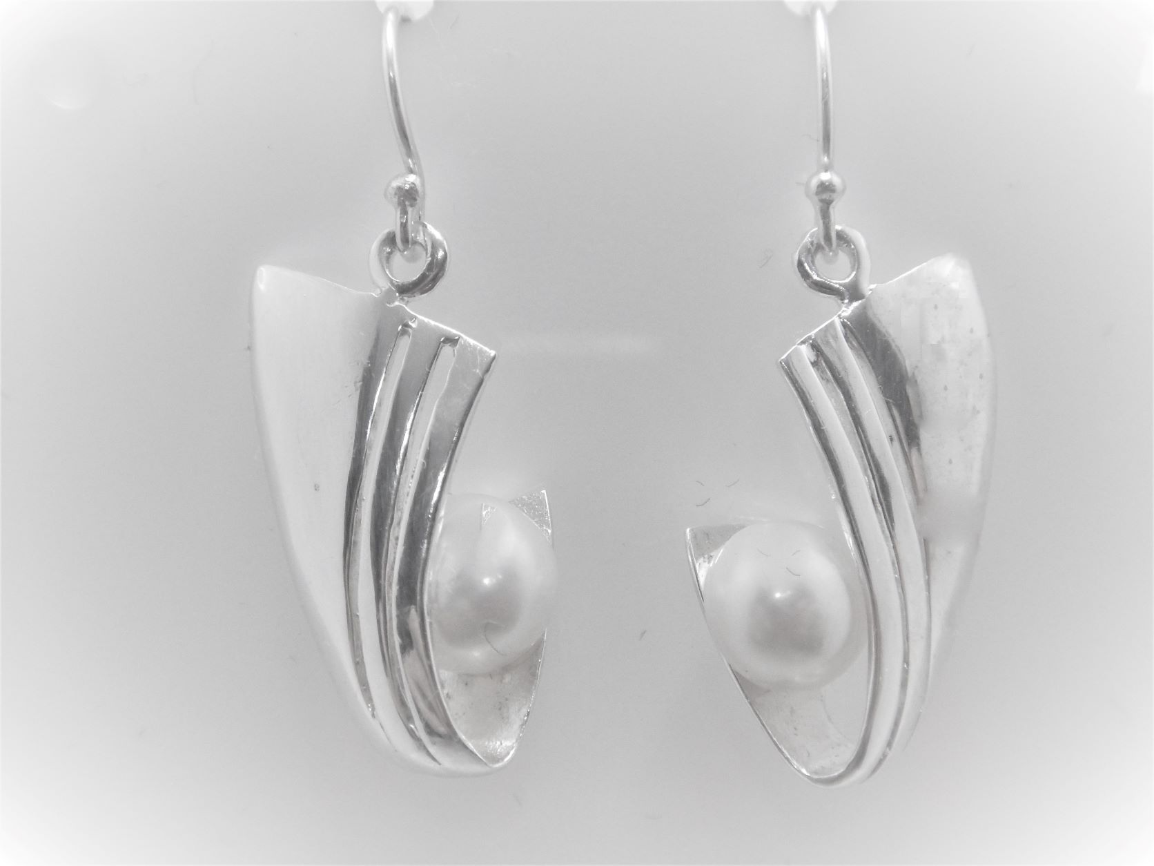 Rhodium plated 925 sterling silver earrings with natural freshwater pearls Approx size  34.5mm long Matching pendant available