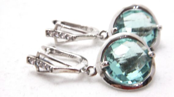 Rhodium plated 925 sterling silver earrings set with white & aqua coloured cubic zirconia  Approx size  32.5mm long x 15mm diam Matching pendant available