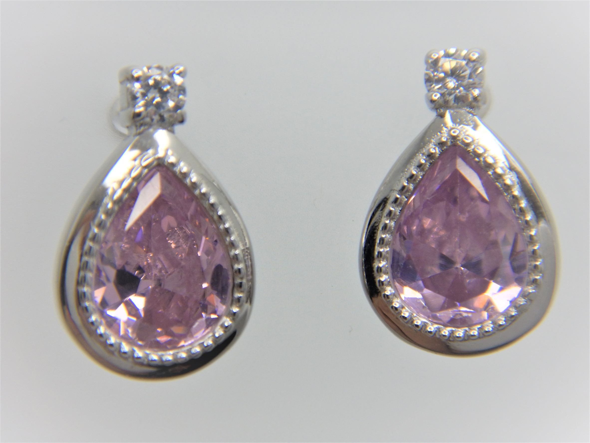 Rhodium plated 925 sterling silver earrings with white & pink CZ