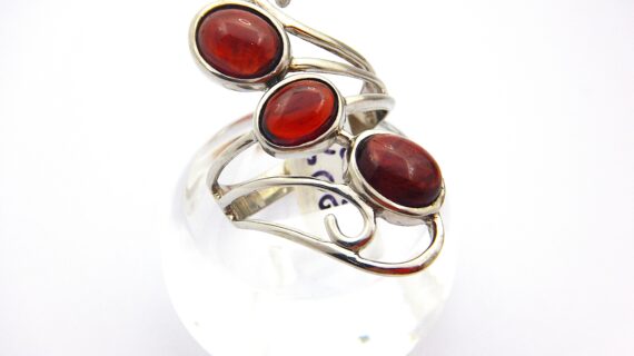 Rhodium plated 925 sterling silver ring set with 3 natural Garnets Approx size  34.8mm long