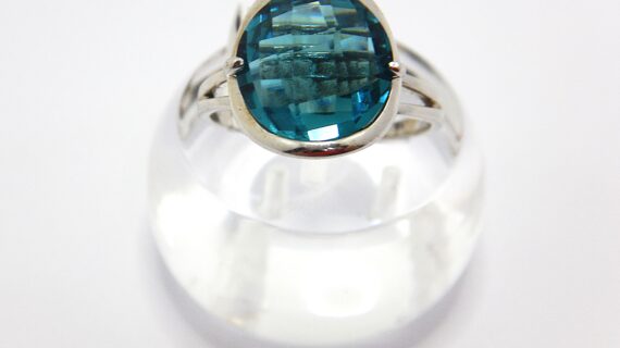 Rhodium plated 925 sterling silver ring set with synthetic blue stone Approx size  14mm diam