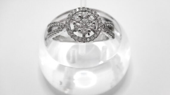 Rhodium plated 925 sterling silver ring set with white CUBIC ZIRCONIA  Approx size  11mm diam