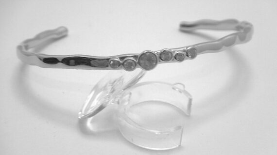 Rhodium plated 925 sterling silver bangle set with natural white topaz Approx size  5mm wide        60mm diam